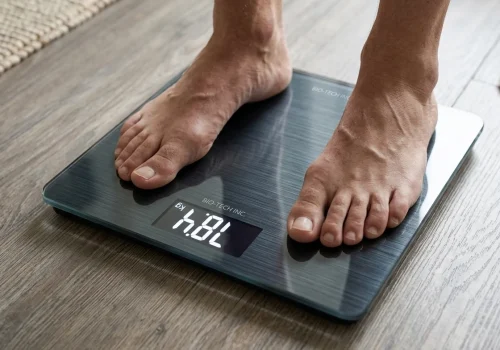 Person checking their weight on a digital scale